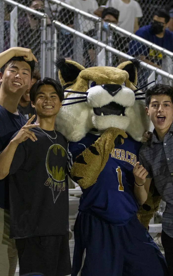 Fans posing with the mascot