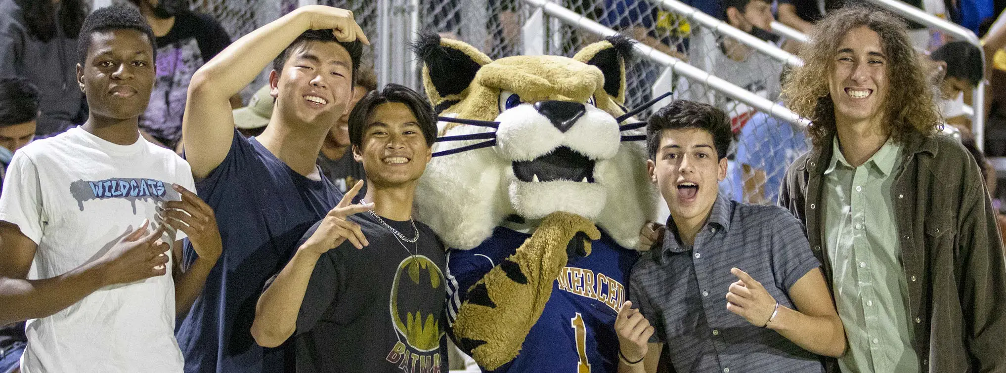 Fans posing with the mascot